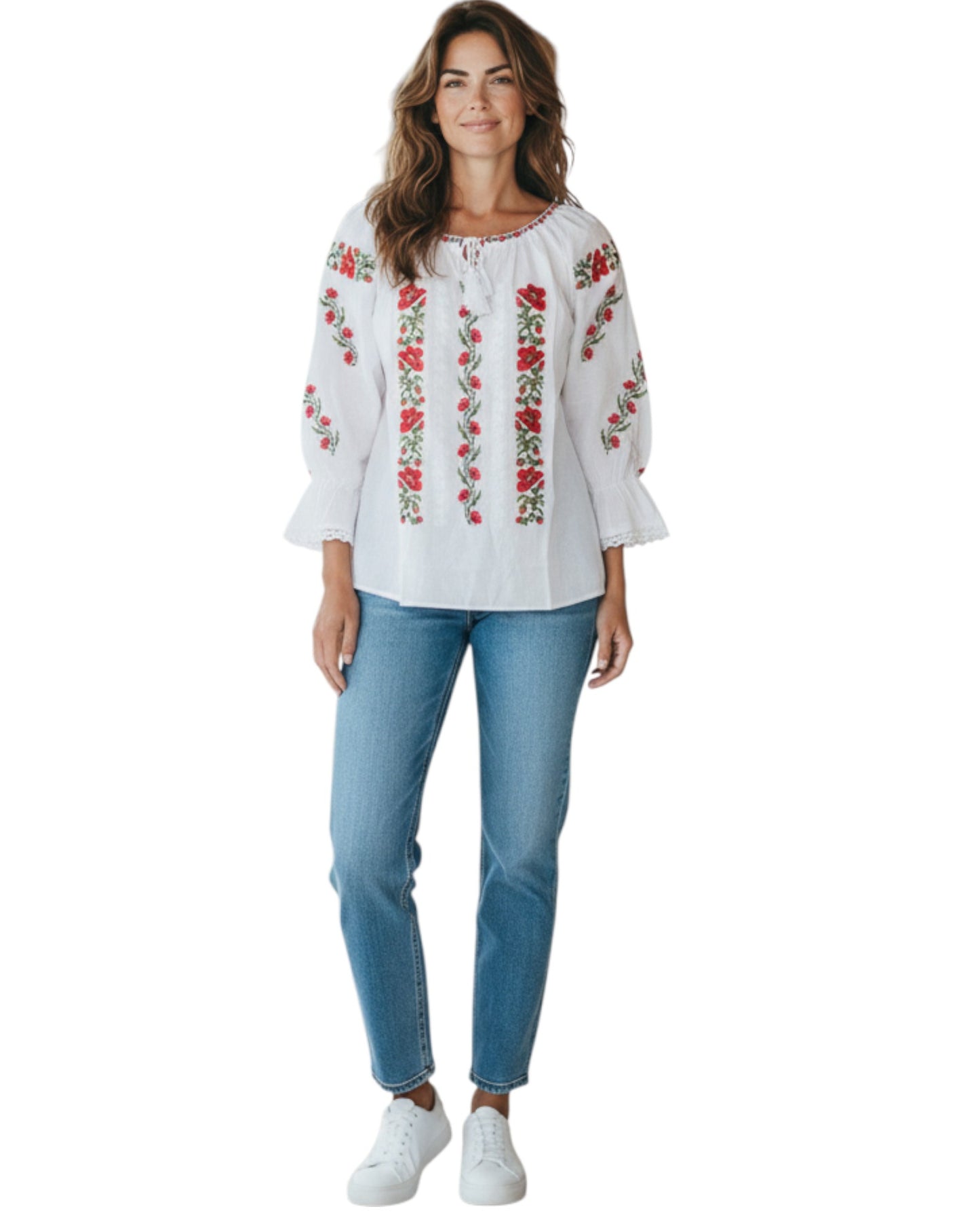 Woman wearing a white blouse with red floral embroidery and blue jeans on a white background
