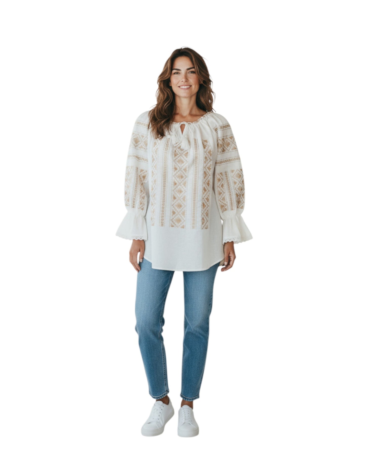 Woman wearing a white embroidered blouse and blue jeans on a white background