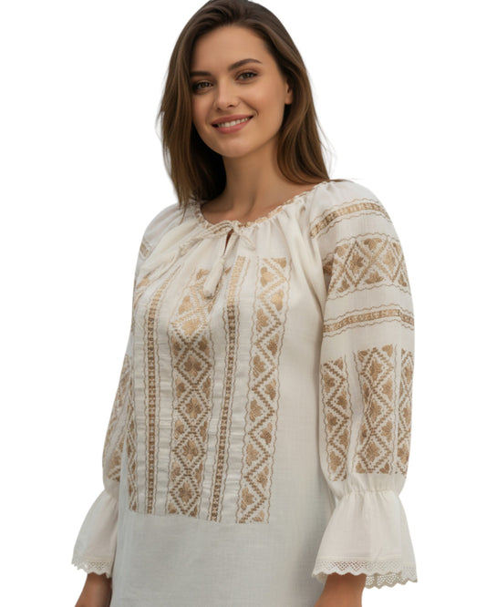 Woman wearing a white blouse with intricate brown patterns on a white background