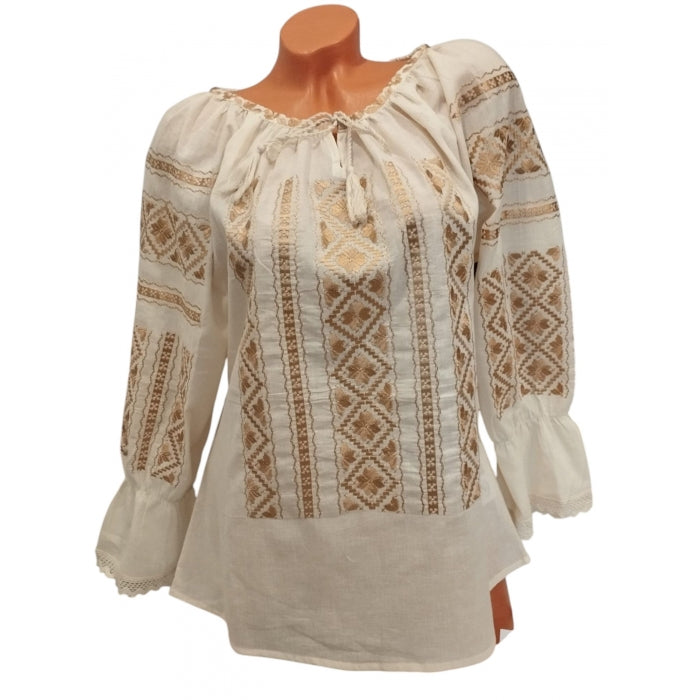 Beige blouse with intricate patterns on a mannequin against a white background