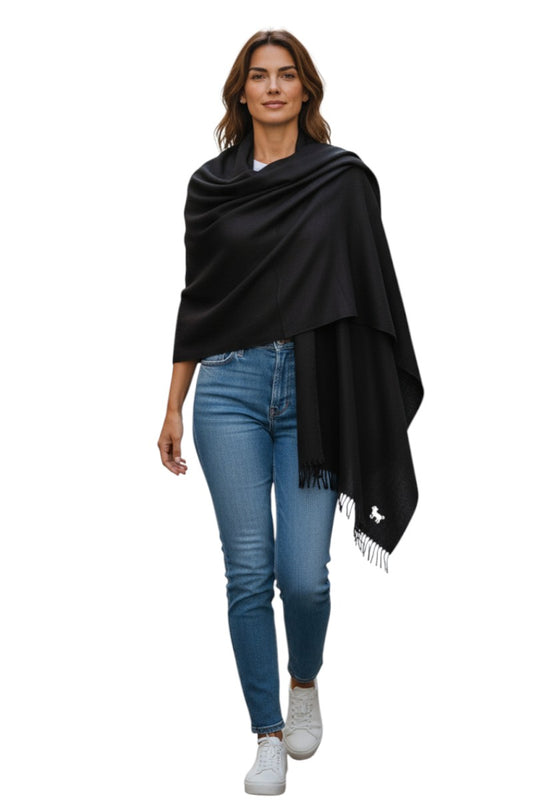 Woman wearing a black scarf and blue jeans on a white background